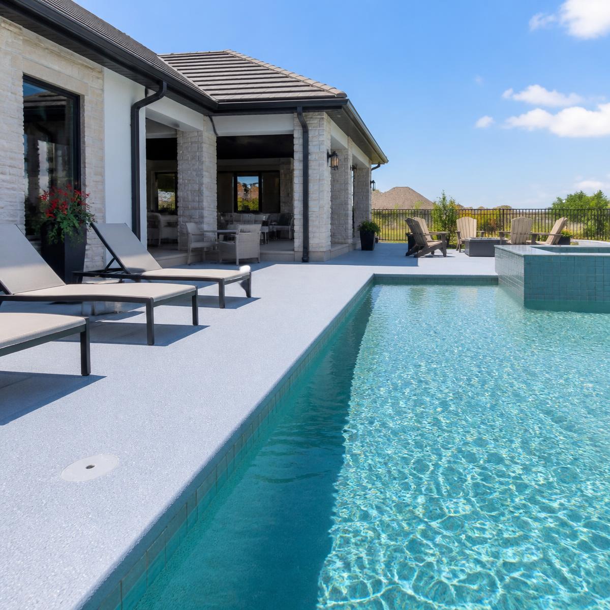 Residential pool deck finished with a light cool deck spray finish in Houston